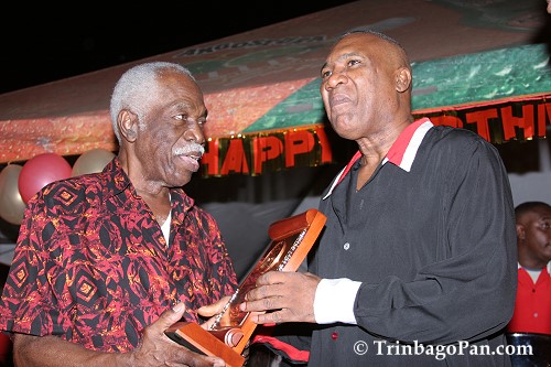 Len 'Boogsie' Sharpe (Right) presents Mr. Neville Jules with a token of appreciation